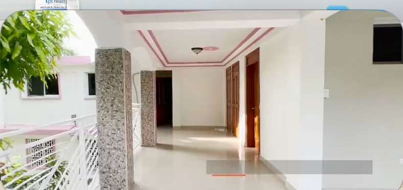 Elegant corridor with stone columns, pink trim ceiling and polished floors