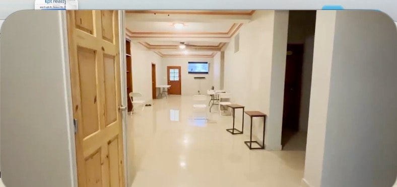 Bright interior hallway with polished floors and lounge area