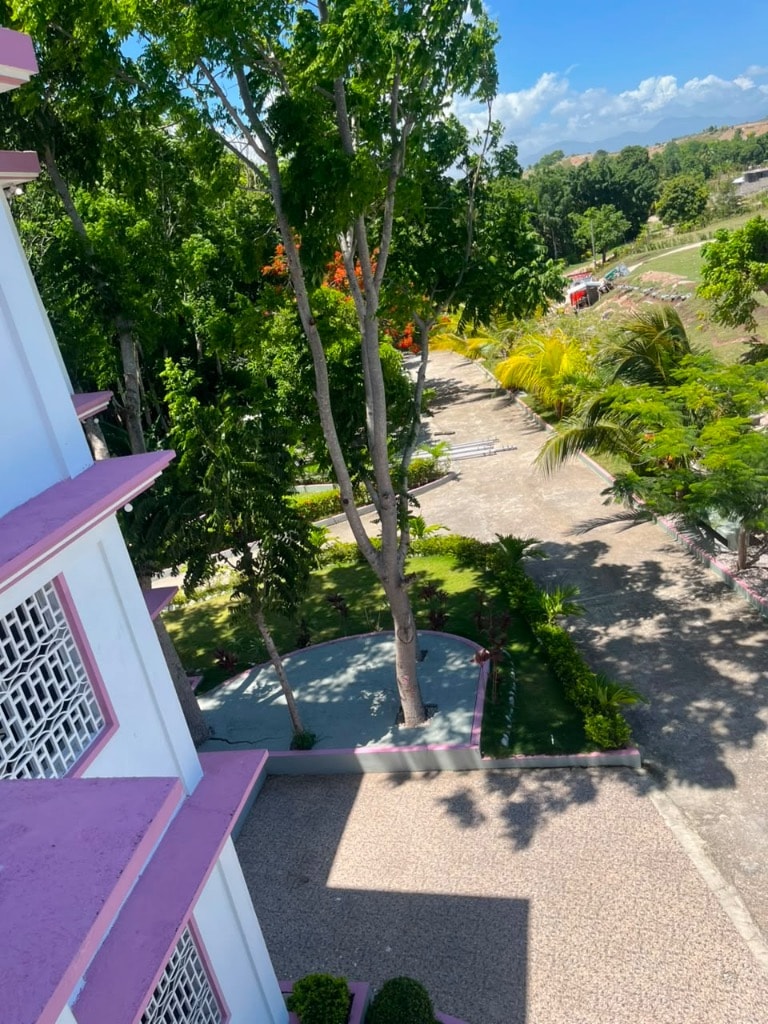 Aerial view of Villa Rêve Créole grounds with pink trim and tropical trees